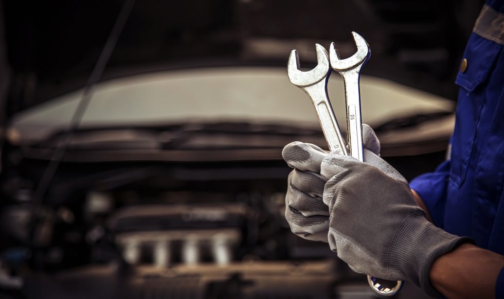Car care maintenance and servicing, Close-up hand technician auto mechanic using the wrench to repairing change spare part car engine problem and car insurance service support.